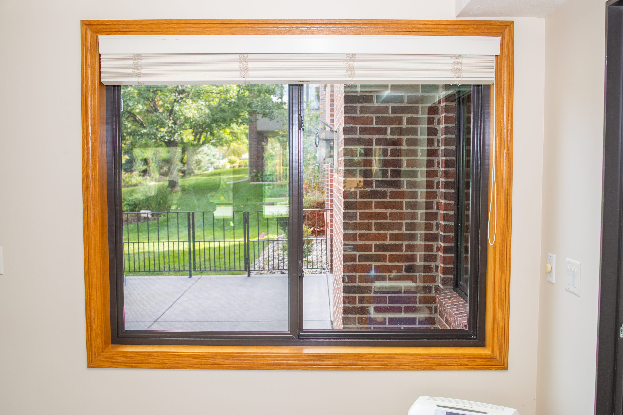 Brown Impervia window with stained trim basement