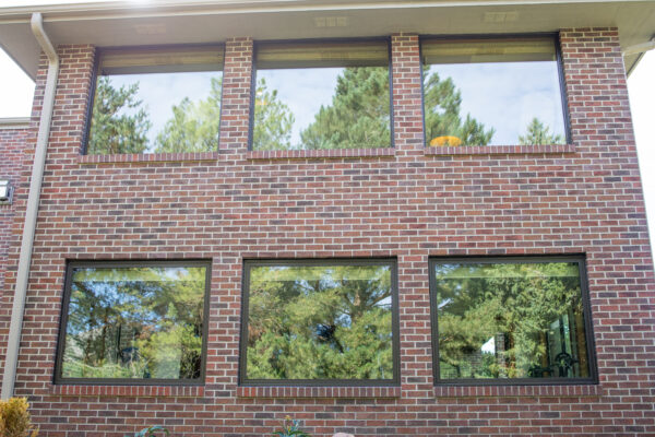 Brick home exterior with brown Lifestyle picture windows