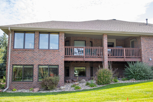 Brick home exterior with brown Lifestyle windows
