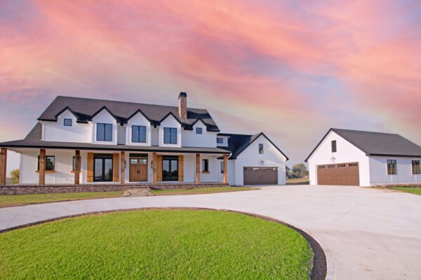 Modern farmhouse and garage at sunset