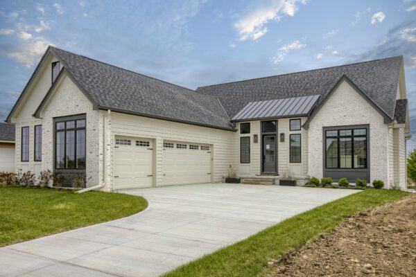 White ranch house with black Pella windows