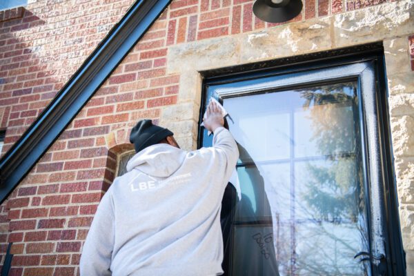 Expert installer cleaning storm door