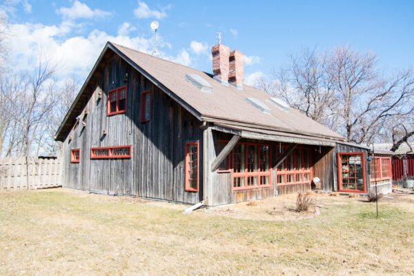 Rustic home with red Pella Reserve windows