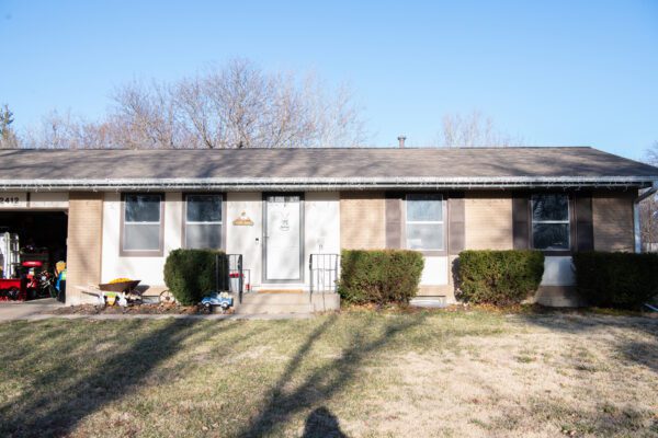 front of brick home before window replacement