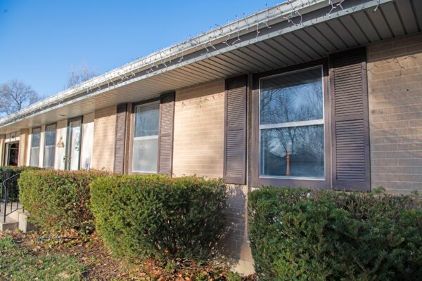 brick home before window replacement