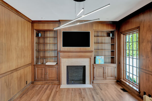 Wood paneled library Pella door