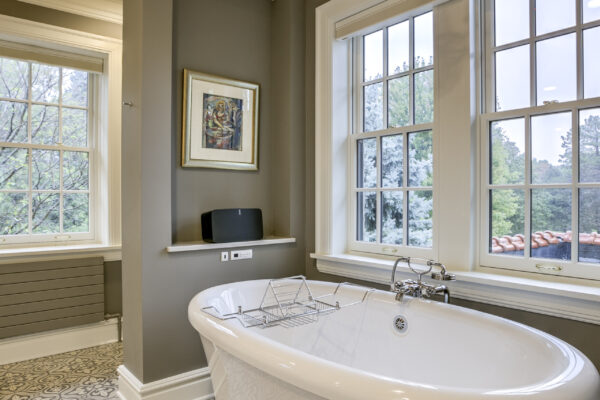 Clawfoot tube with double hung windows above it
