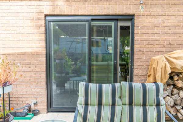 Black Impervia sliding patio door partially open
