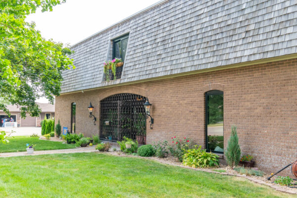 Black sliding patio door replacements on brick home