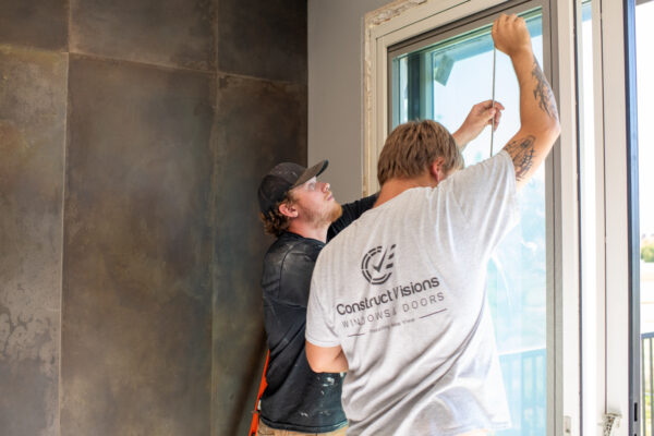Experts installing a Pella sliding patio door