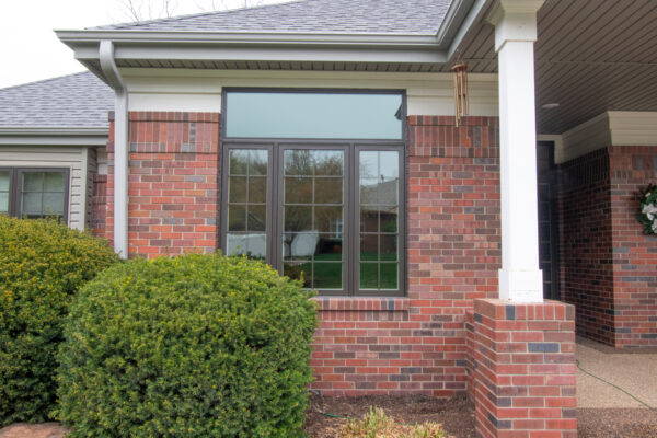 Exterior brown Pella Lifestyle casement window with grilles