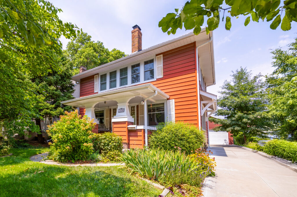 Red historic home after window replacement