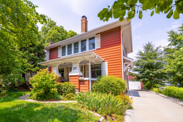 Red historic home after window replacement