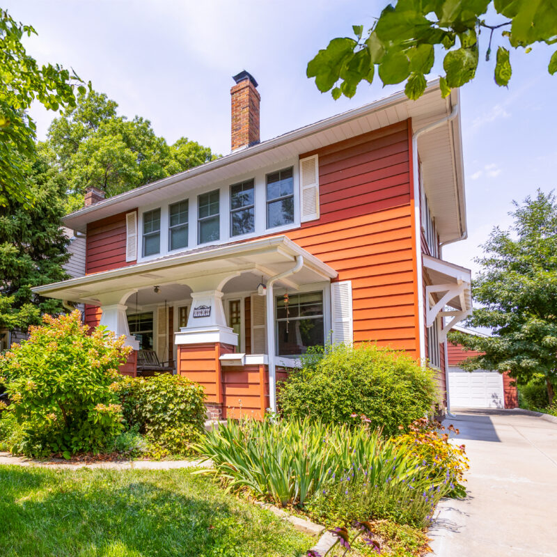 Red historic home after window replacement