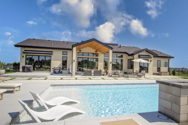 Black Pella windows at back of house elevation pool