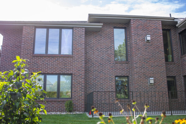 Brick home exterior with brown Lifestyle casement windows